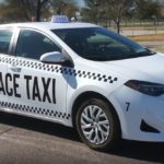 A white taxi on the road